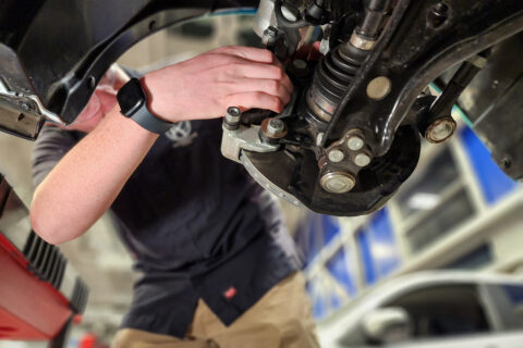 Student Changing Brakes on car