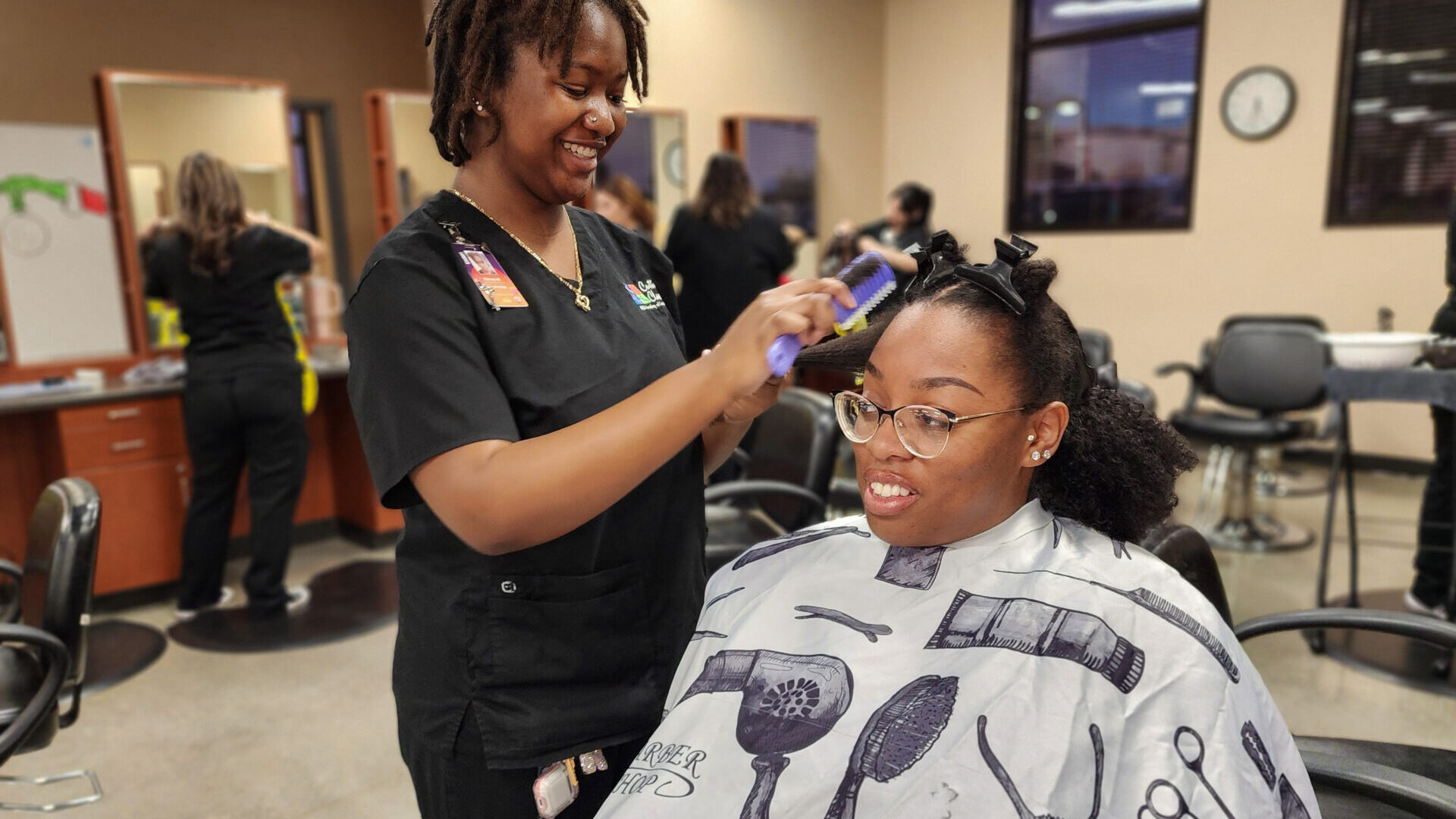 Student styling customer hair