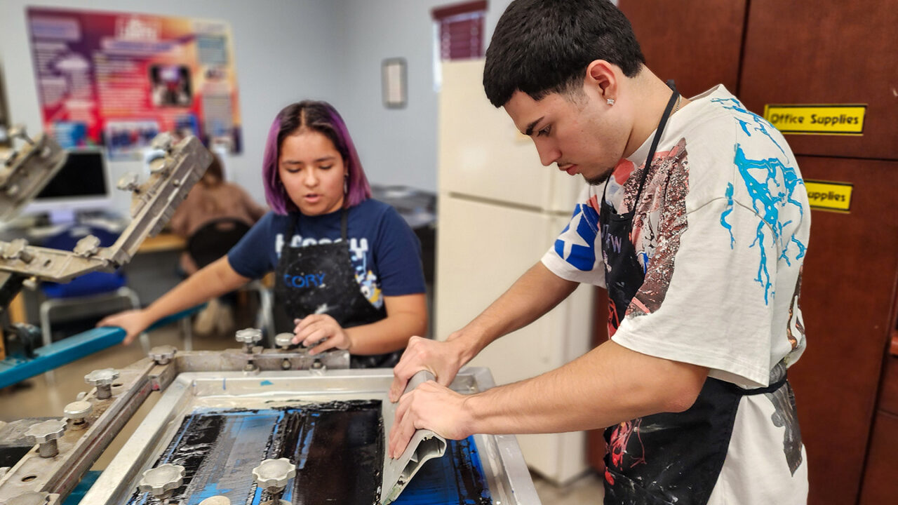 Students using screen printer