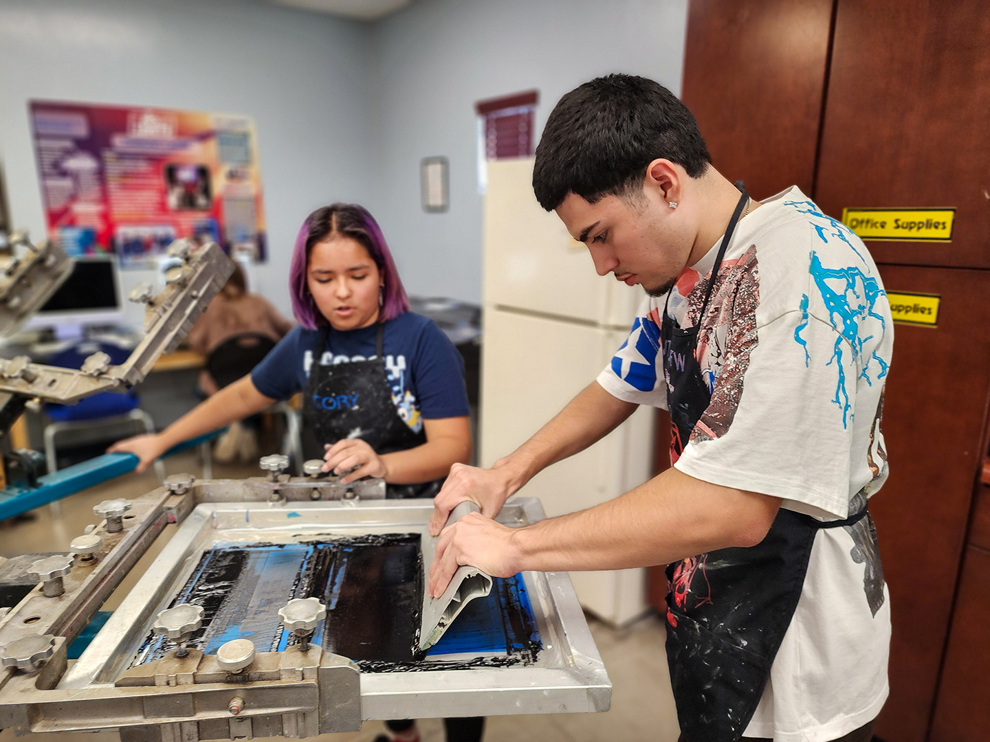 Students using screen printer