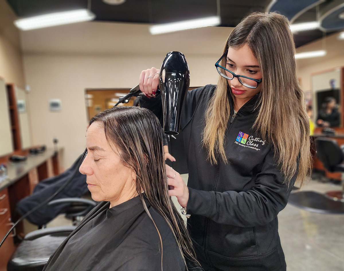 Student blow-drying hair