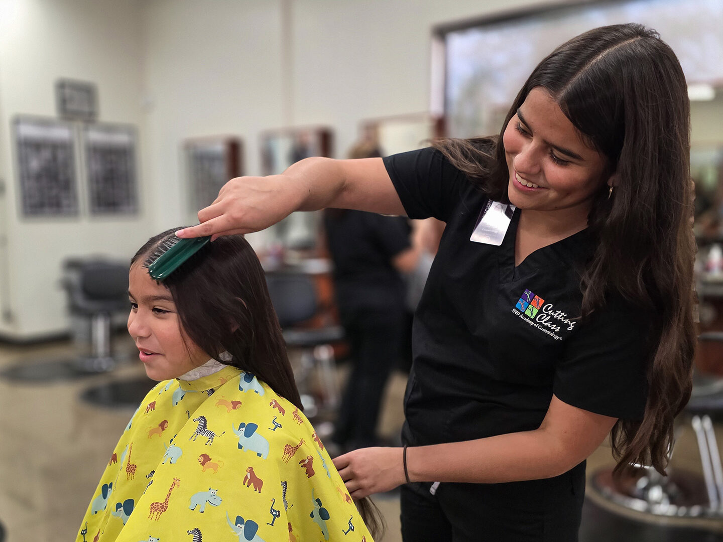 Student brushing customer's hair