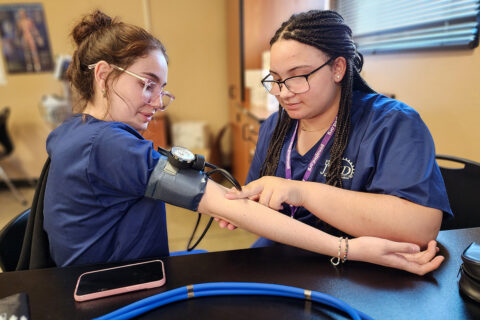 Student checking pulse