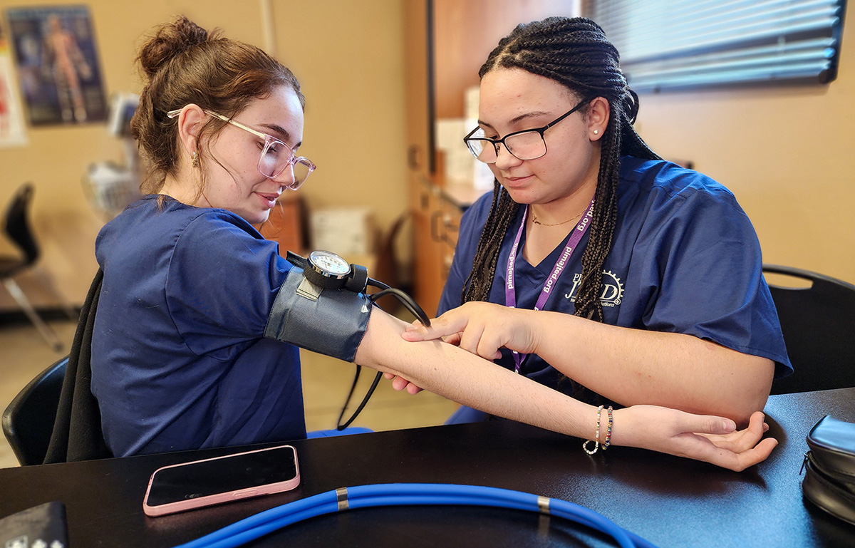 Student checking pulse