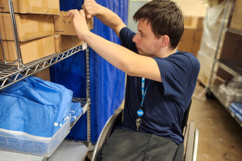 Boy tearing cardboard box