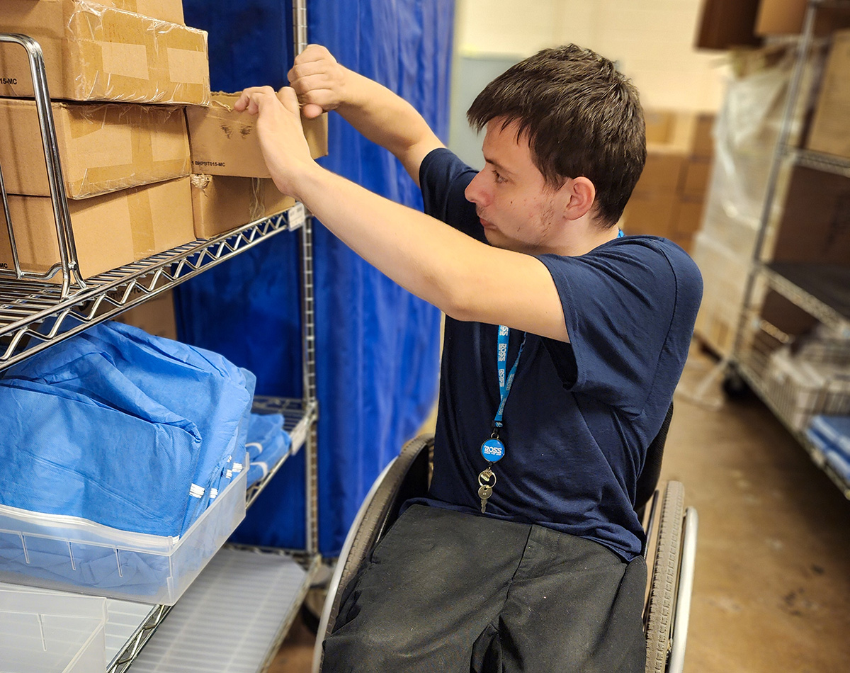 Boy tearing cardboard box