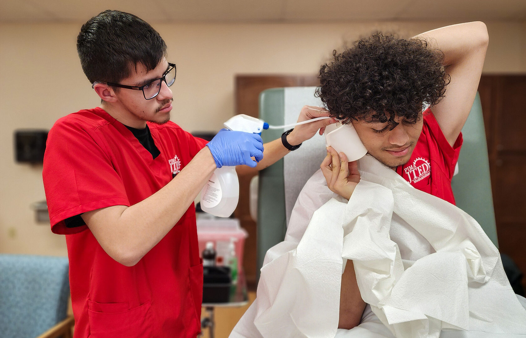 Student performing ear lavage