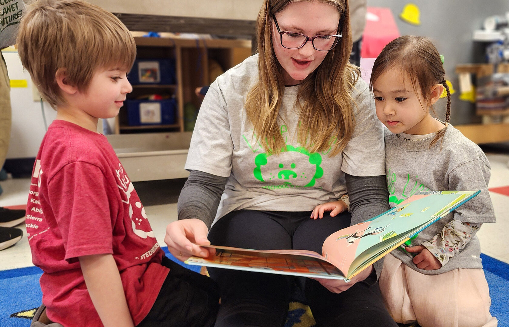 High school student reading to preschoolers