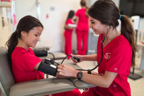 MA Student taking other student's blood pressure