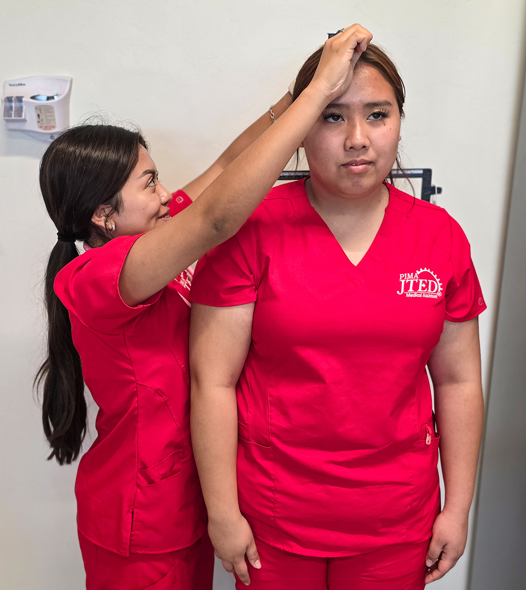 MA student measuring height of patient