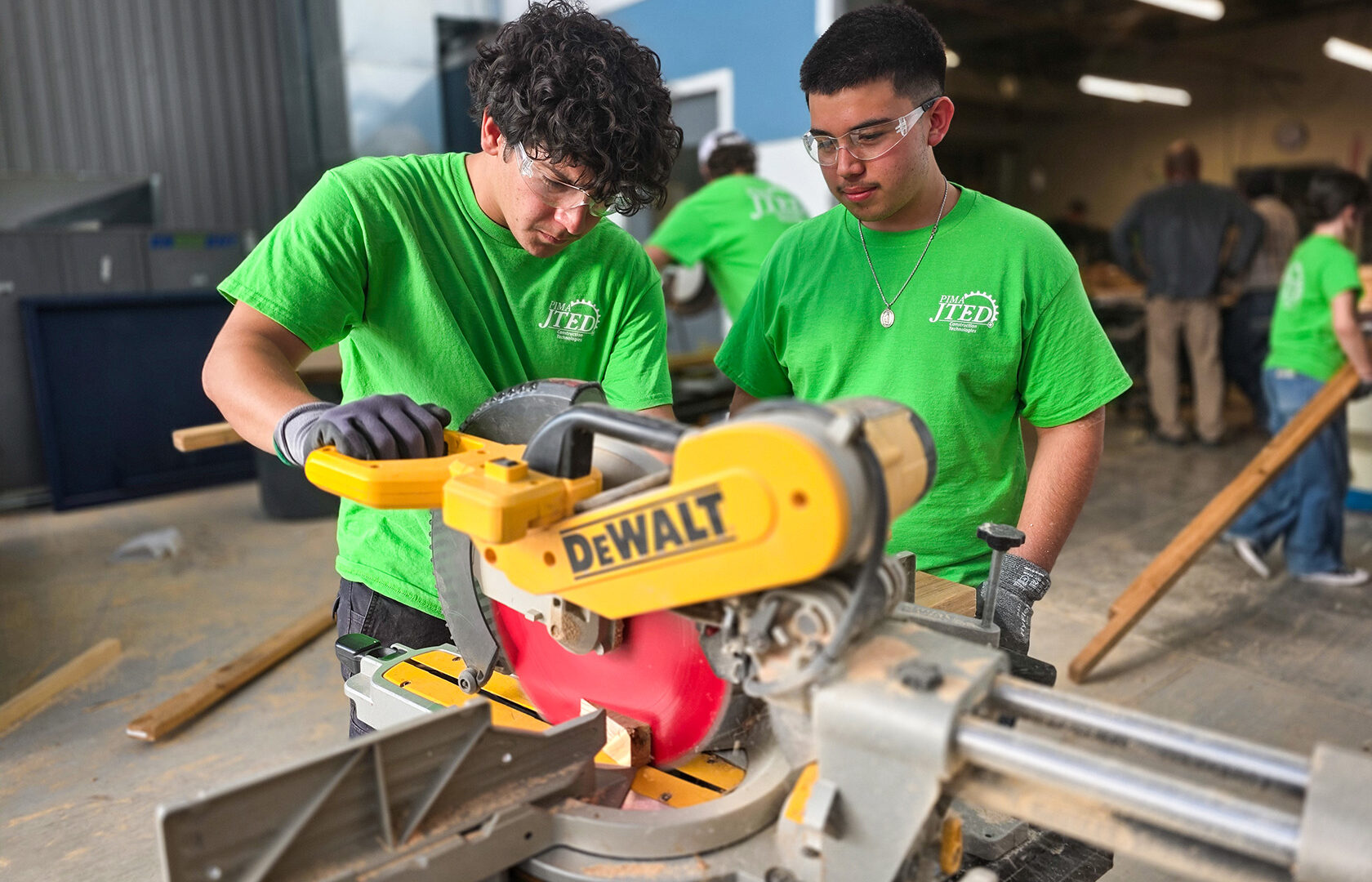 Construction students using saw