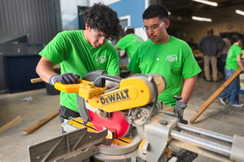 Construction students using saw