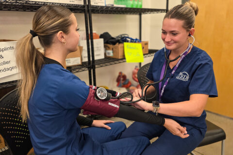 Student taking blood pressure