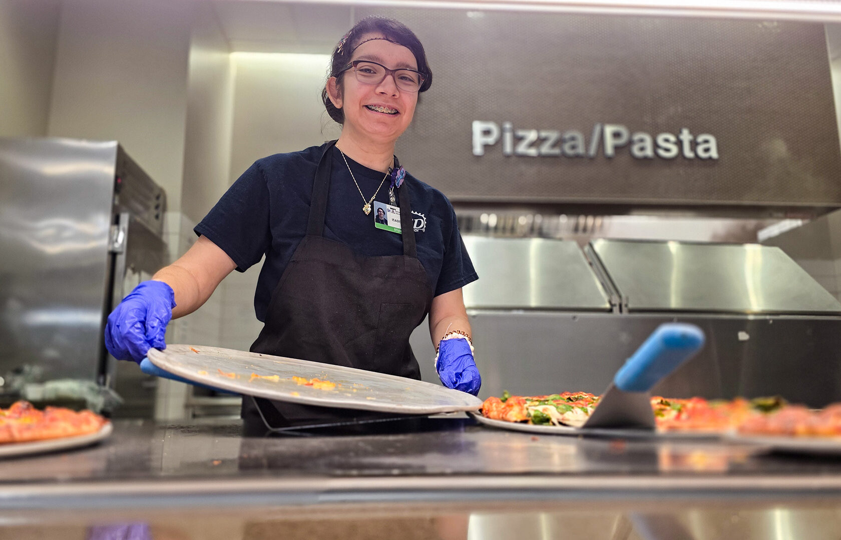 Student removing pizza tray
