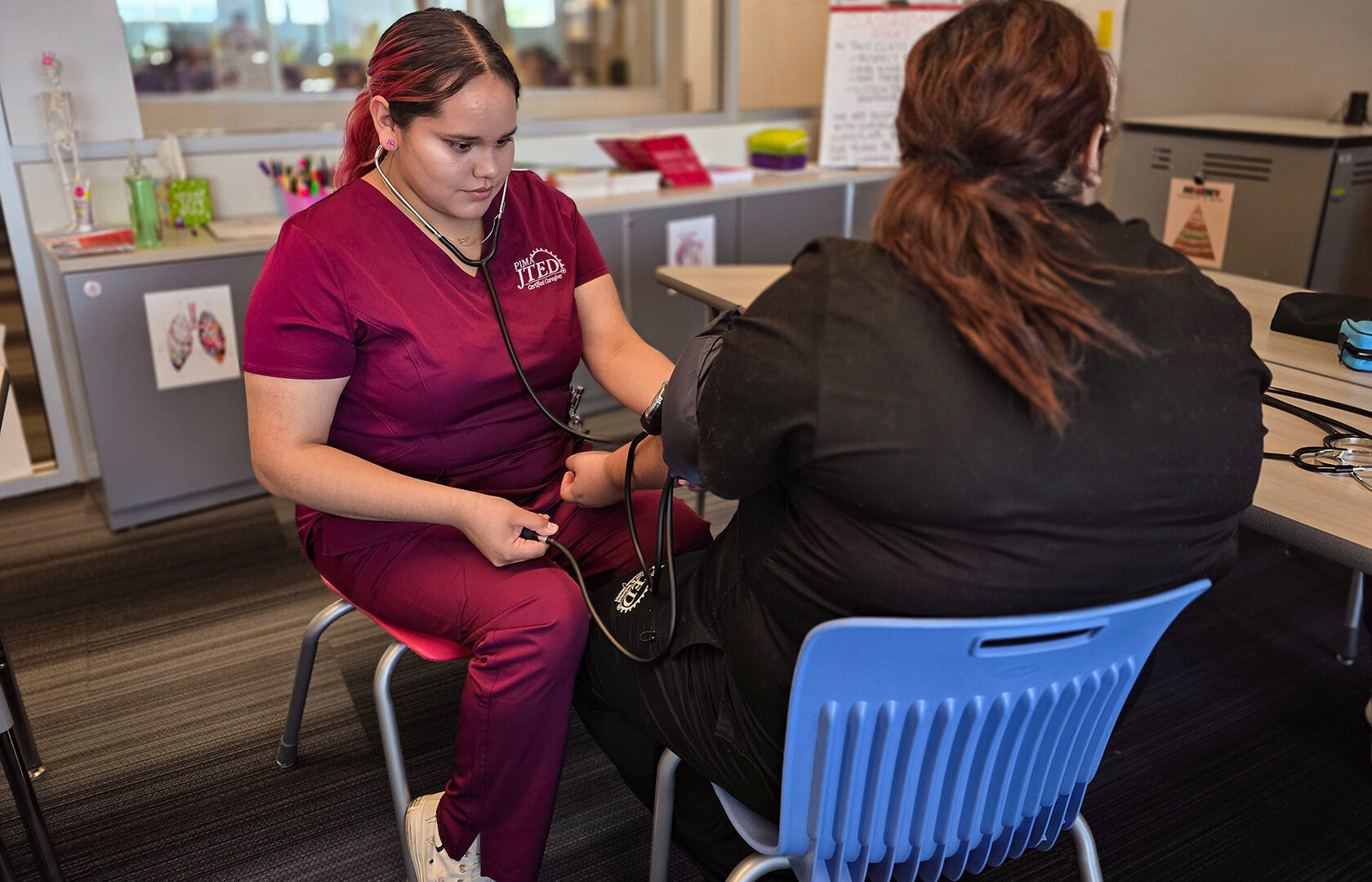 Caregiver student taking blood pressure