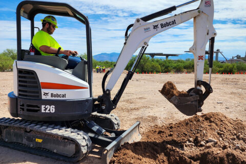 Student using mini excavator