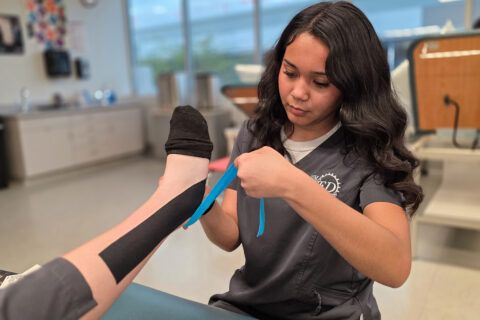Student taping ankle