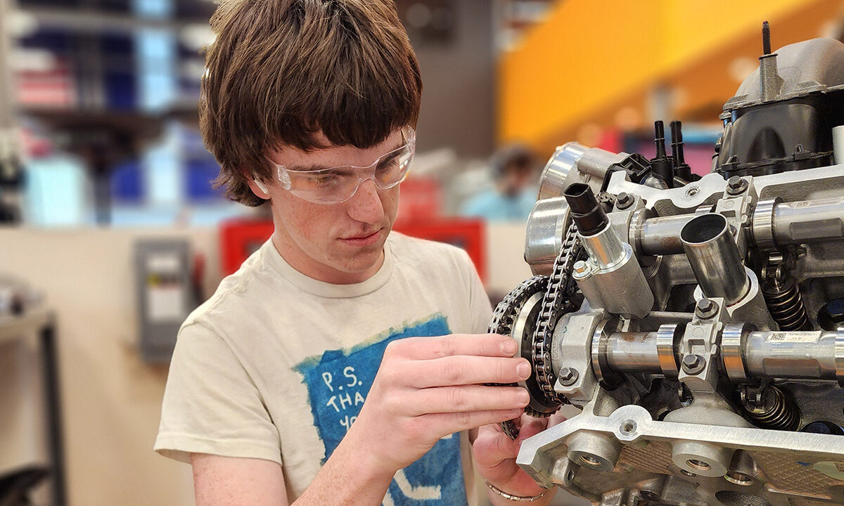 Student working on small engine