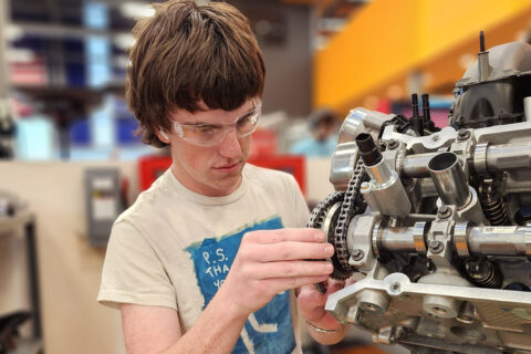 Student working on small engine