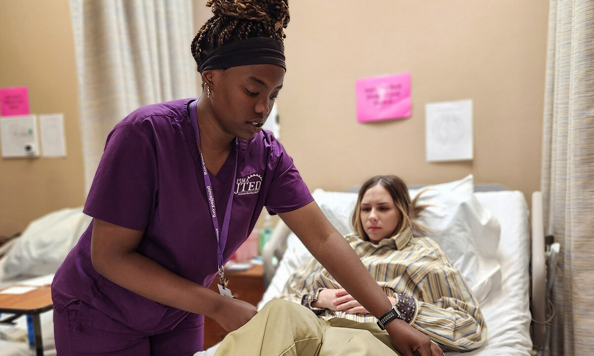 Nursing Student changing patient's clothes