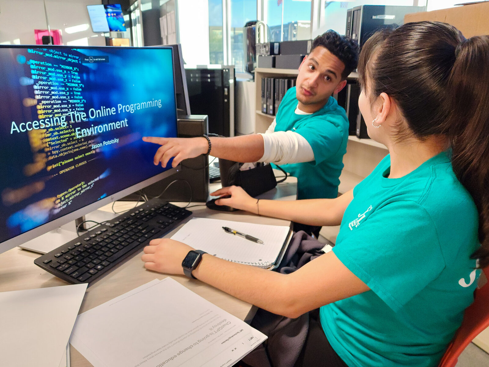 Student pointing at computer screen