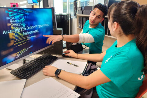 Student pointing at computer screen