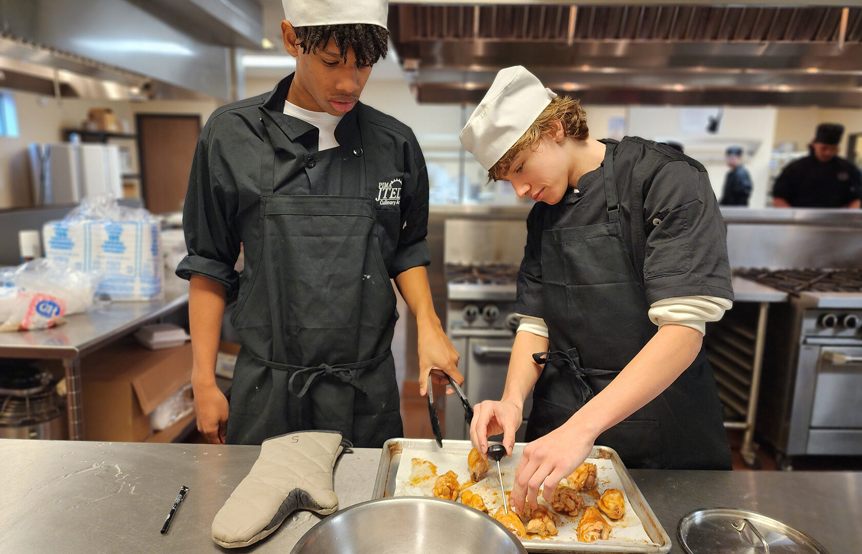 Students checking temperature of chicken wings