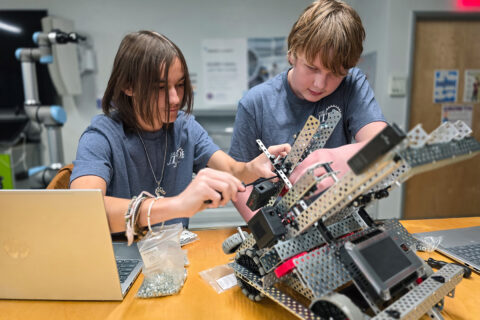 Two students working on a robot