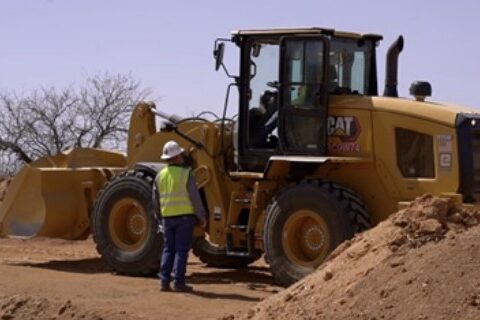 instructor with heavy earth moving equipment