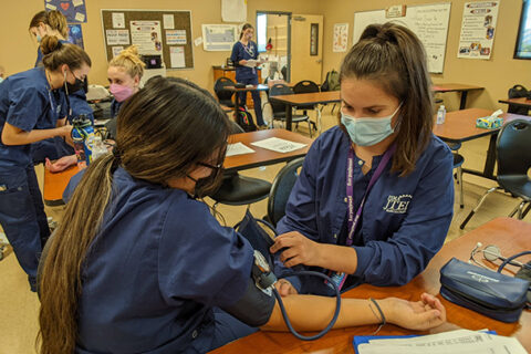 HCF Student checking blood pressure