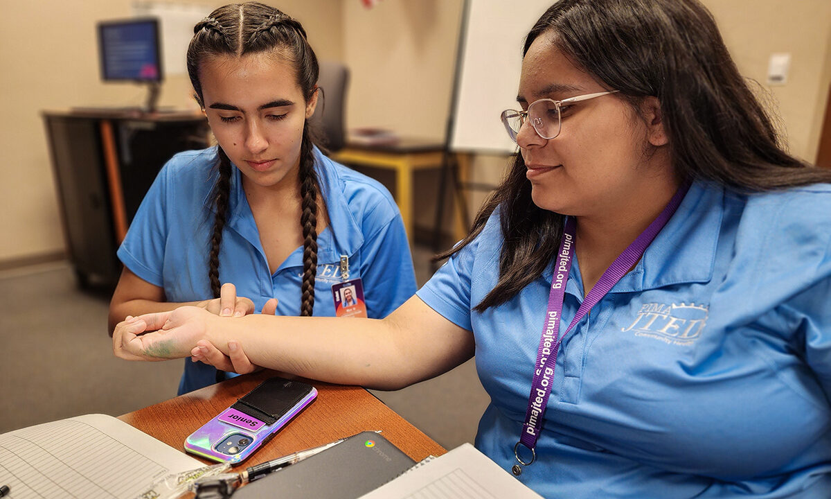 Student checking other student's pulse