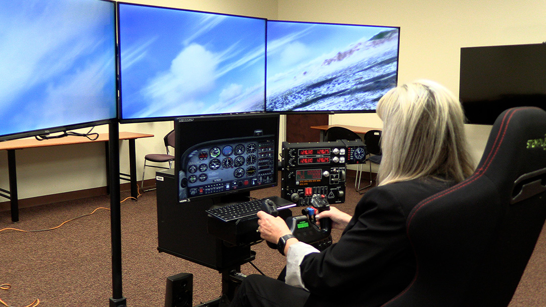 Woman operating flight simulator