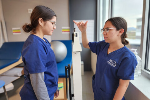 Student taking patient weight