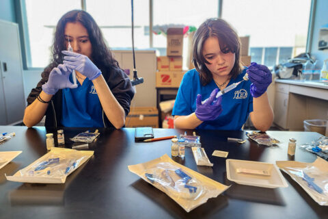 Students drawing compound into syringe