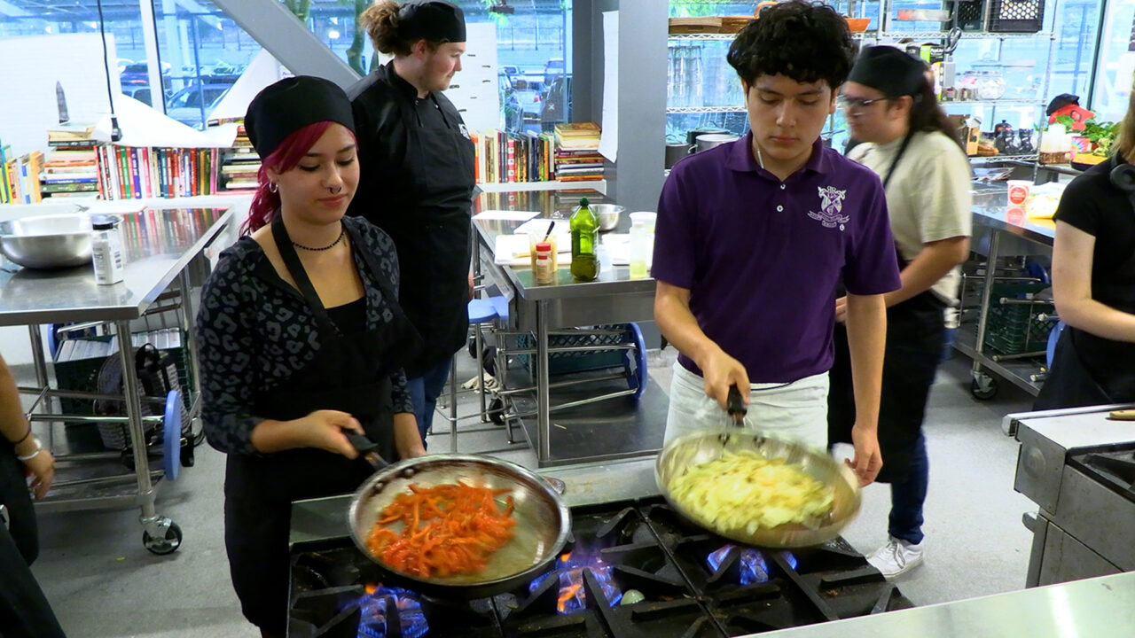 Students cooking on stove