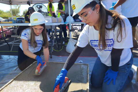 Students smoothing out concrete