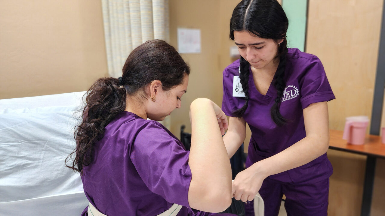 Student applying gait belt