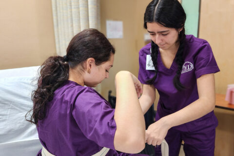 Student applying gait belt