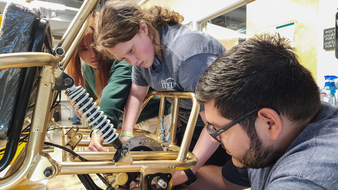 Students working on go cart