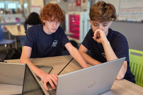 Students looking at computer