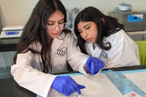 Students dropping liquid into test strip
