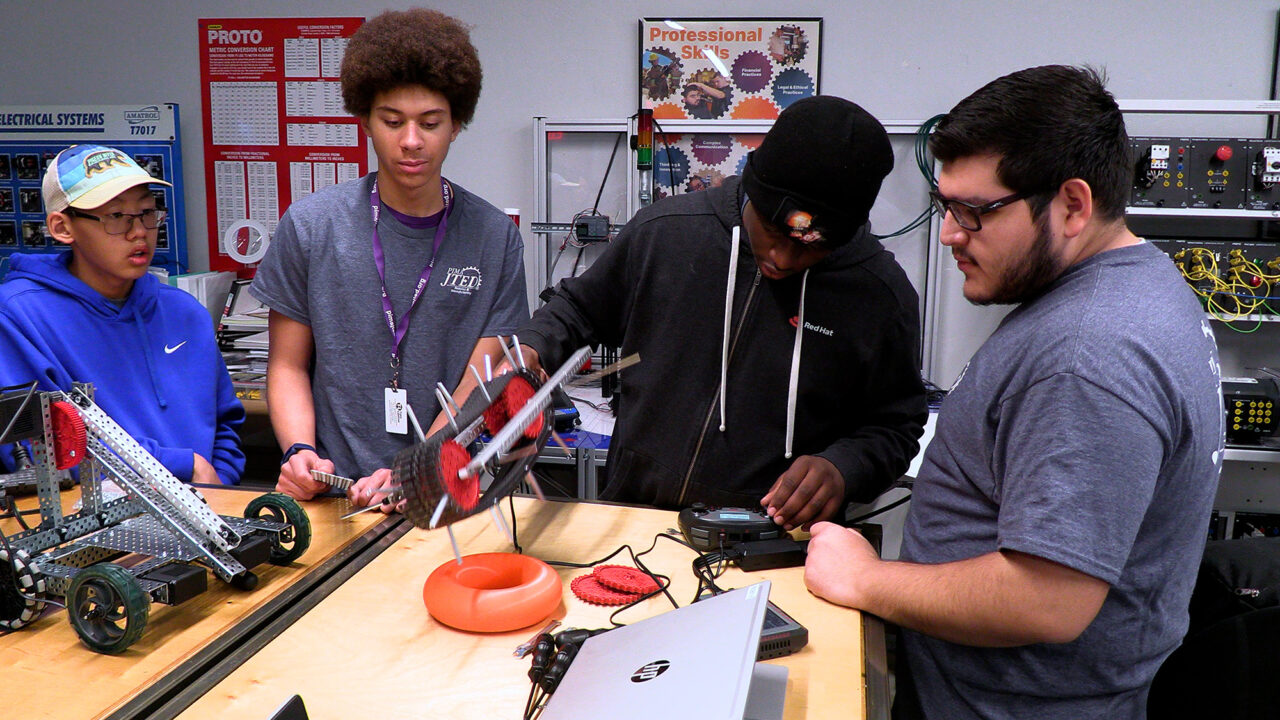 Students testing robotic device