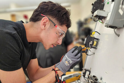Student working on electric panel