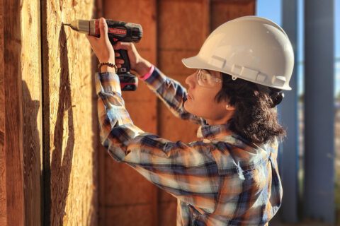 Student drilling screw into wood