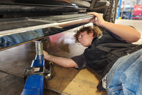 Intern placing lift under truck
