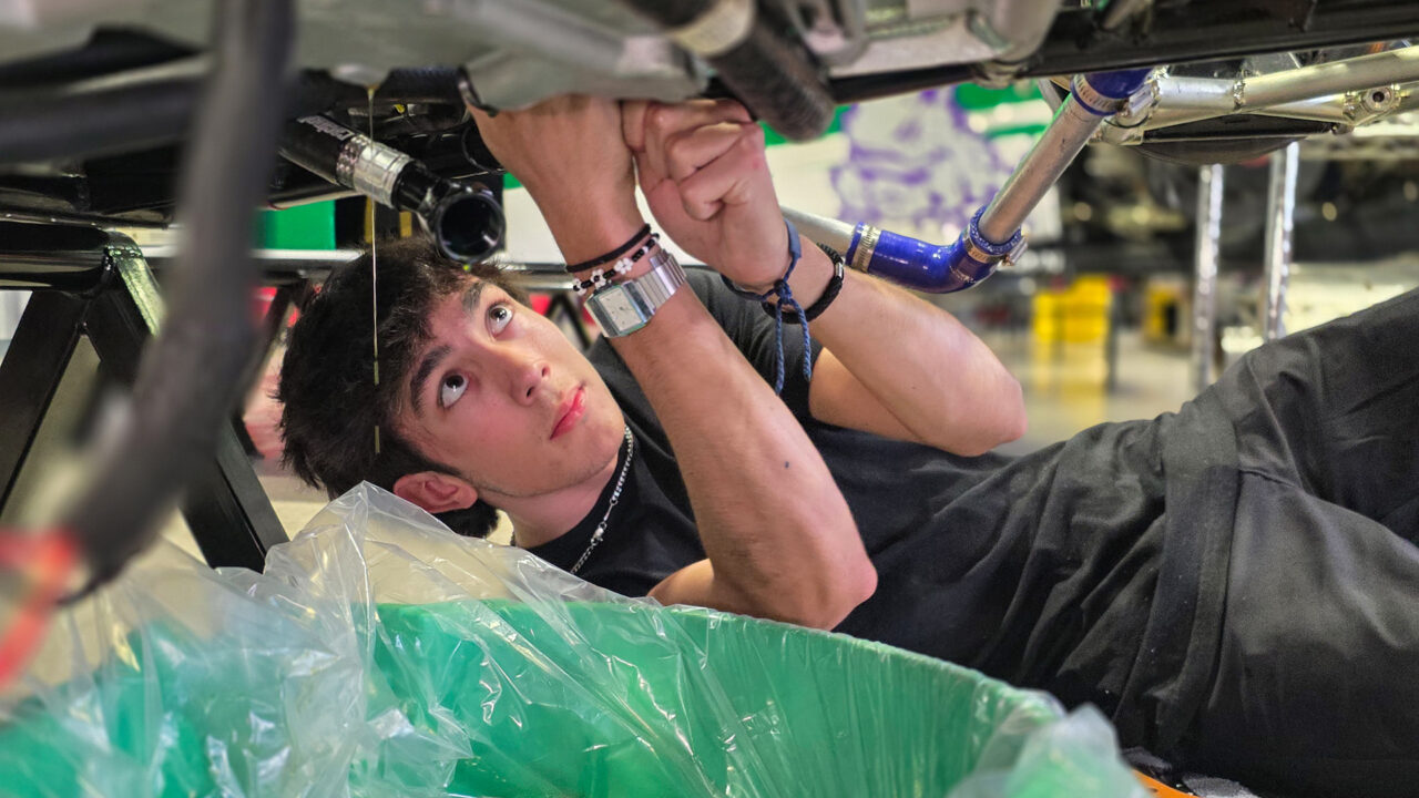 Intern working on race car engine