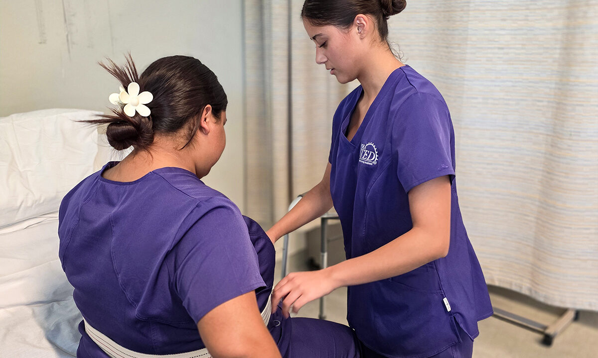 Nursing student applying gait belt