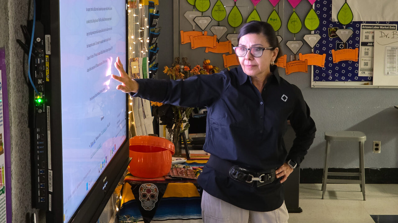 Teacher Pointing at Smart Board