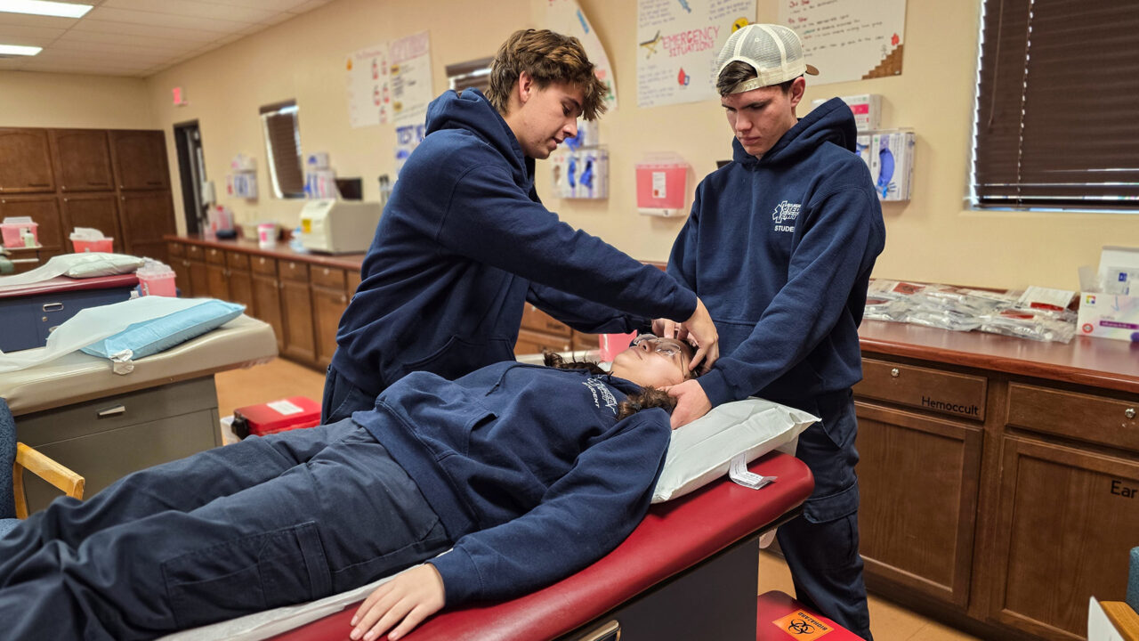 EMT student checking on patient