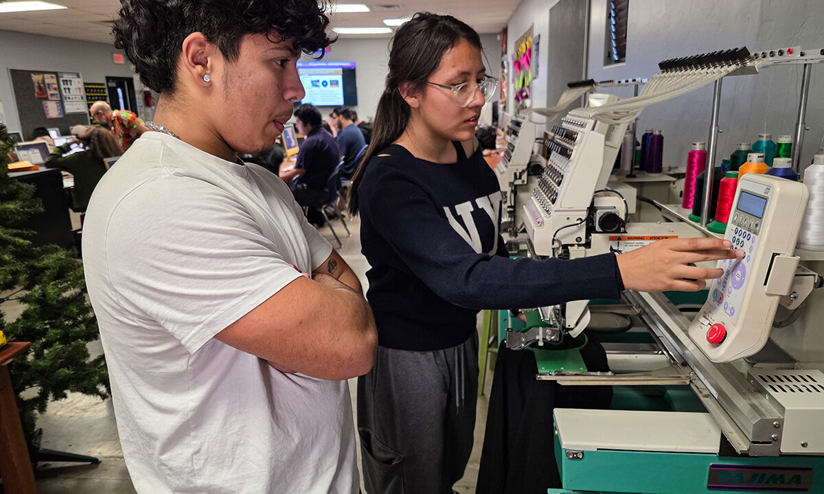 Students working with embroidery machine